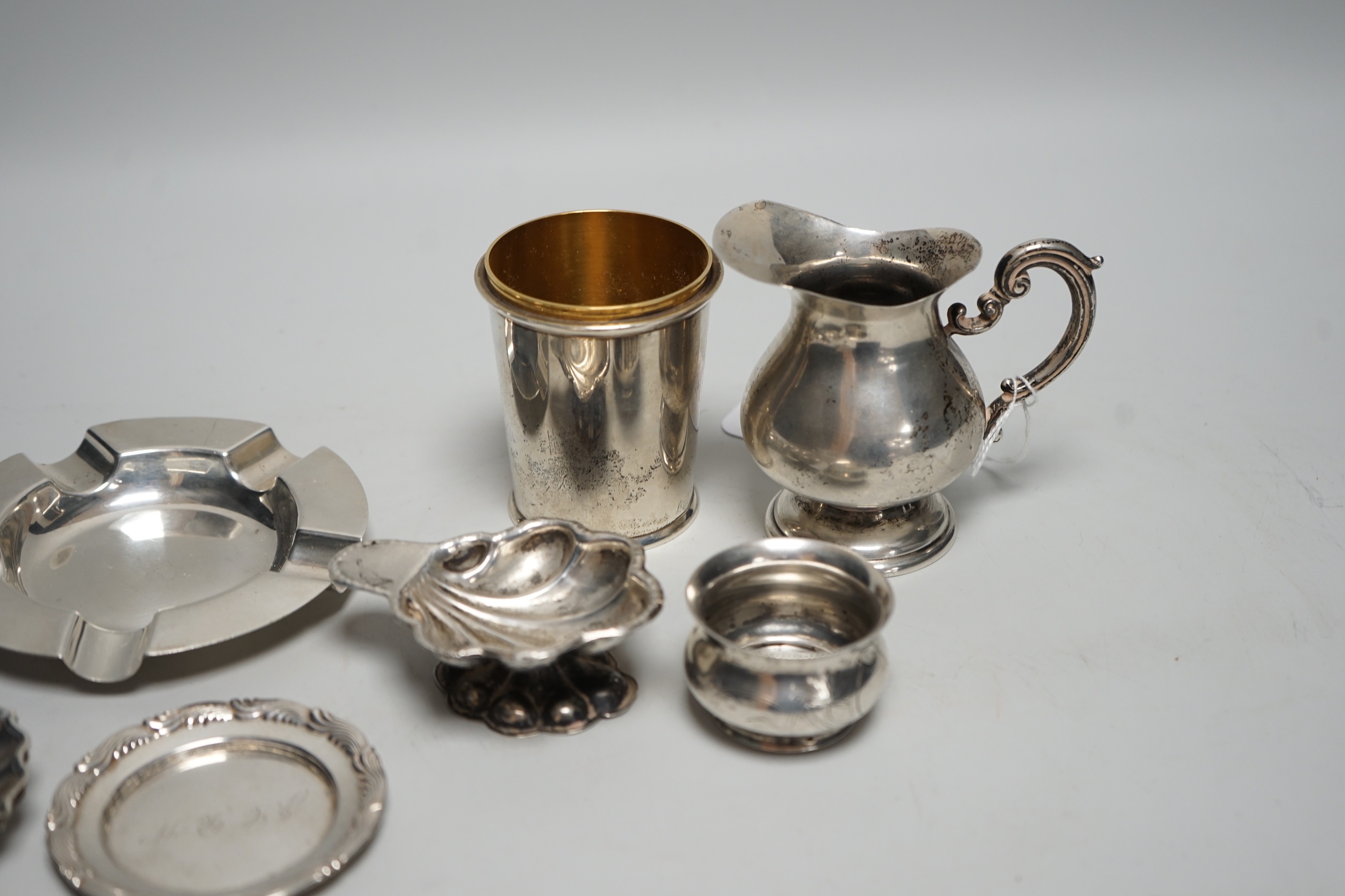 Sundry small silver, including a set of four 800 standard white metal small dishes, a similar shell salt and cream jug, a Tiffany & Co sterling small dish, a modern silver cup base (top missing), a silver ashtray and a R